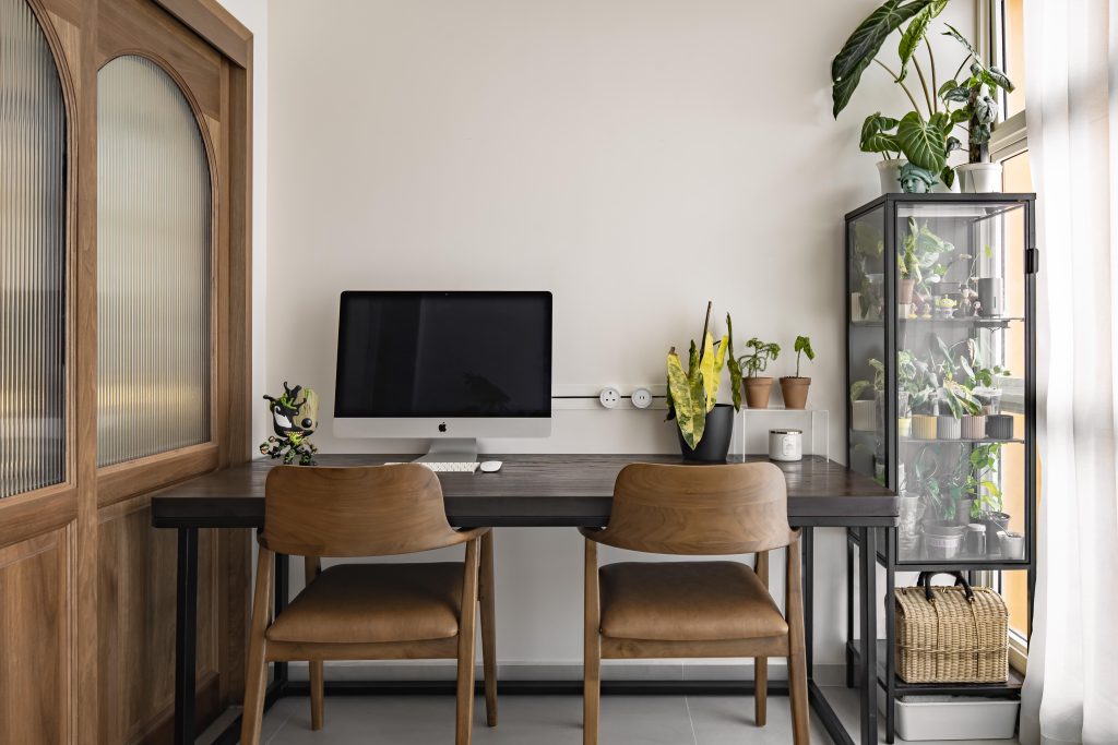 Compact dual workstation with built-in desk and natural finishes, designed by an interior design company in Singapore using commercial-grade home office solutions.