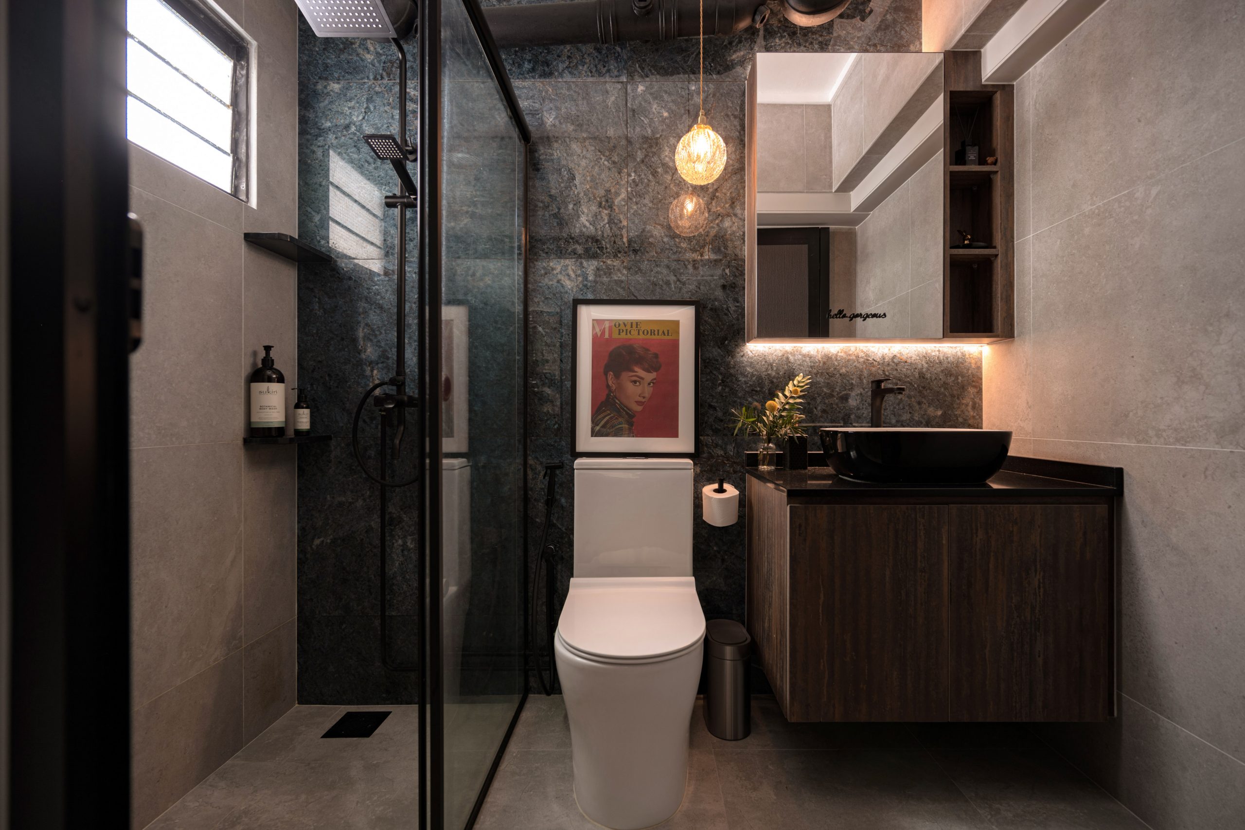 Bathroom renovation Singapore at 17 Telok Blangah featuring dark textured wall tiles, a frameless glass shower screen, and matte black fixtures
