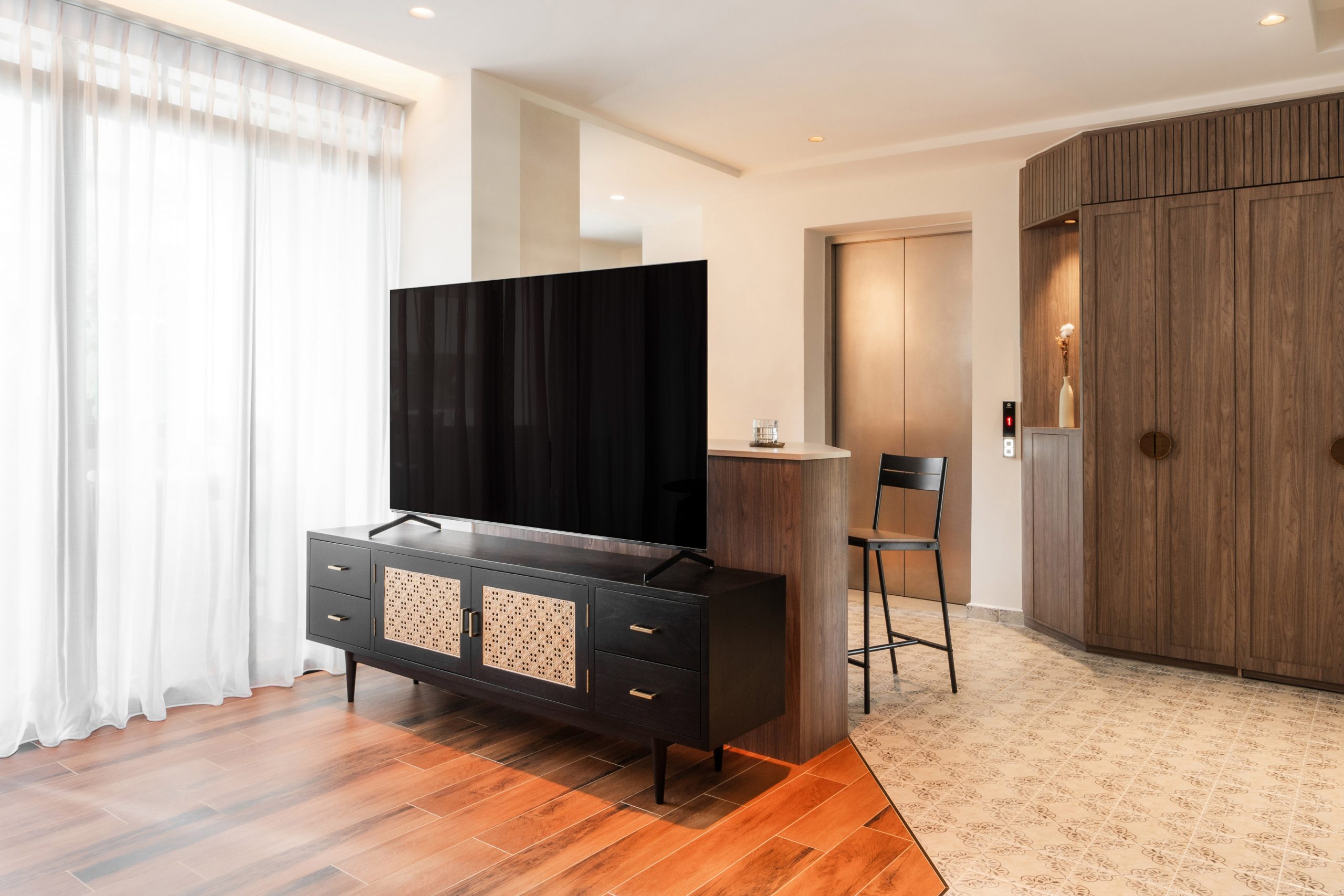 Modern small condo design at Avenue South Residence II featuring an open-concept living area with warm wood accents and minimalist furniture