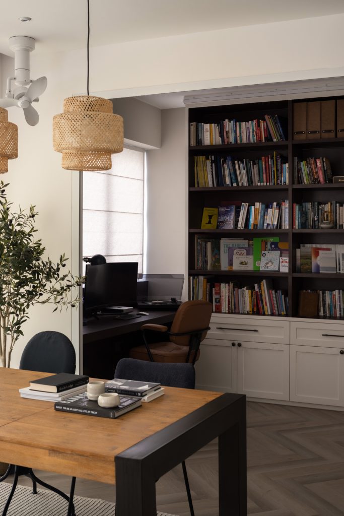 "Stacked books on a shelf in a computer room"