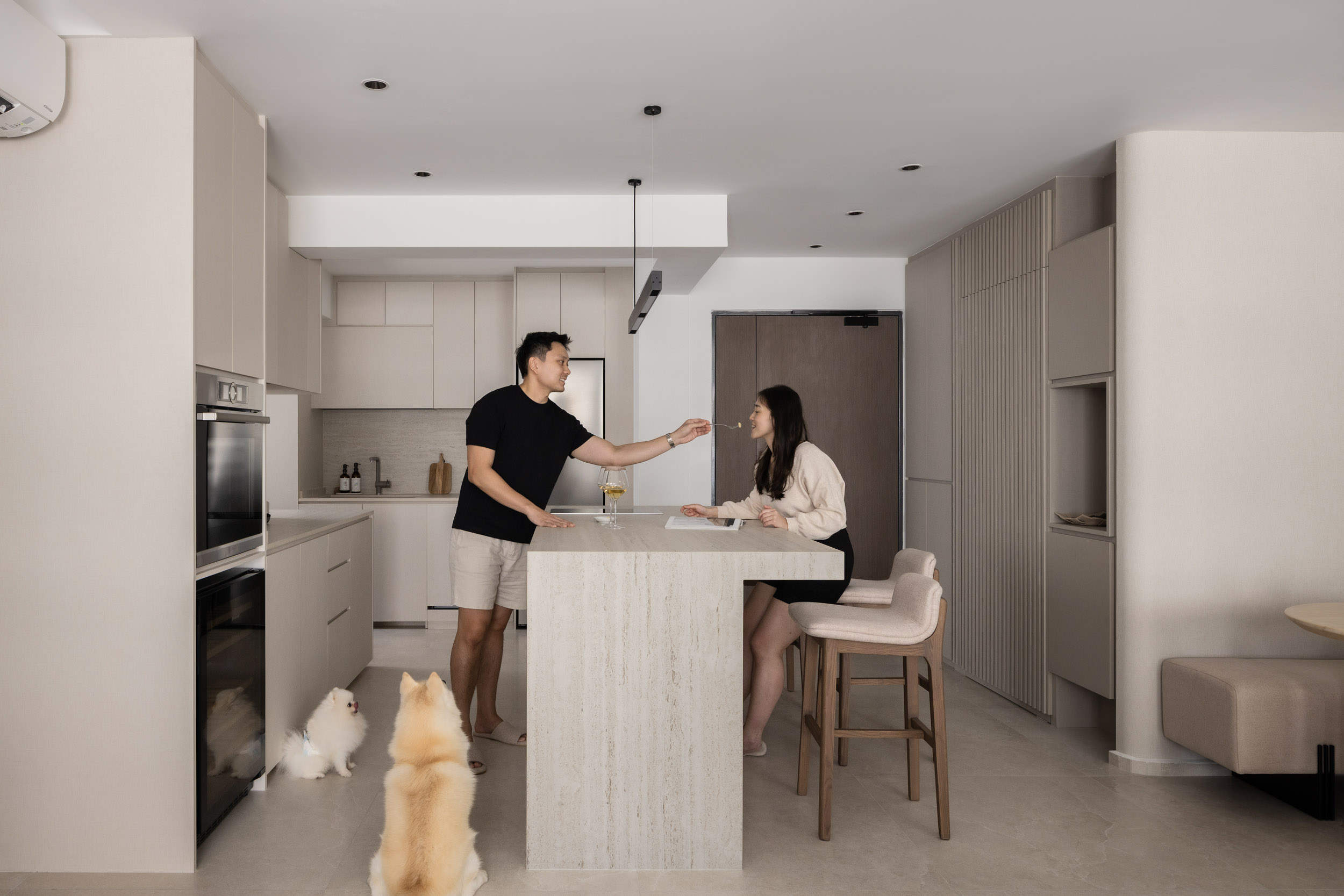 Bright and modern home interior reflecting renovation in Singapore with a central kitchen island and open-plan living concept.